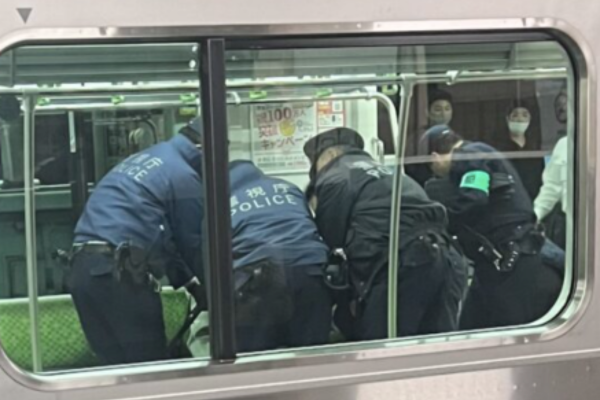 電車の中で犯人を取り押さえる警官たちの写真